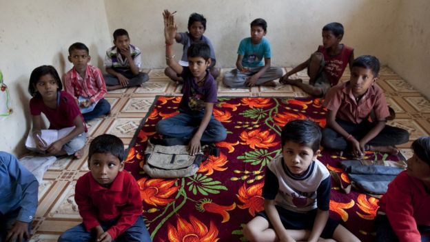Kids studying on floor tiny room of Guldasta School